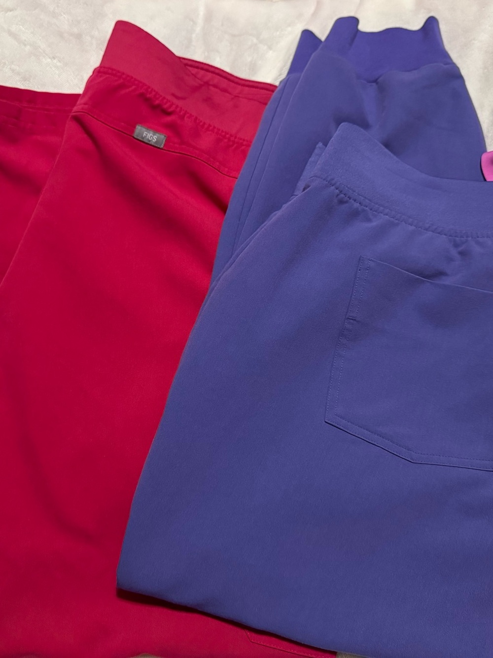 FIGS Technical Collection Scrub Pants in Bright Pink & Purple.